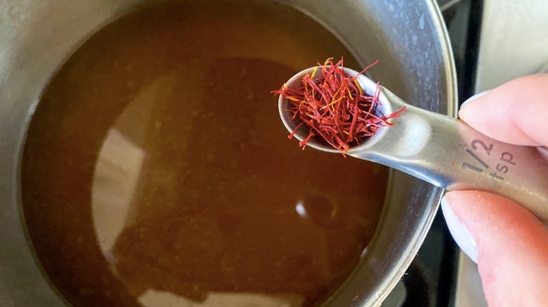 putting saffron threads in broth