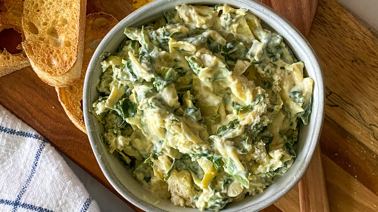 vegan spinach artichoke dip in baking dish