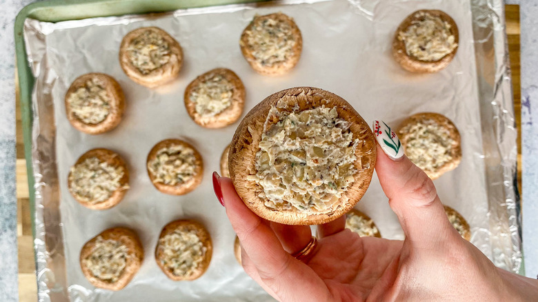 stuffed mushrooms on baking sheet