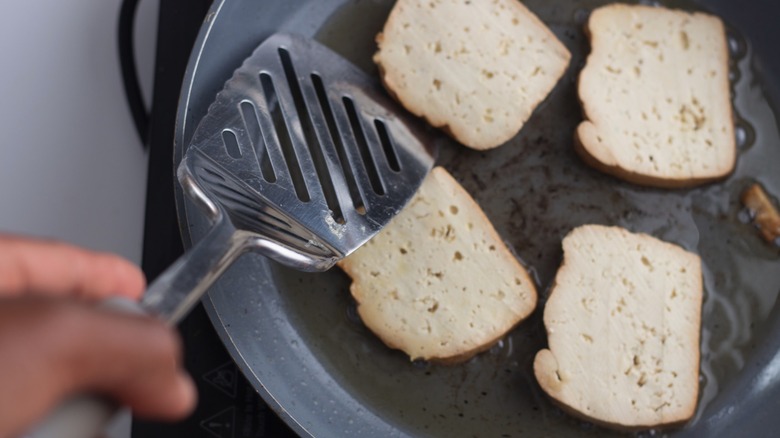 Tofu cooking in a pan