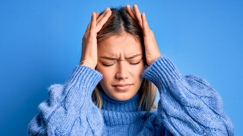 Stressed woman with blue background