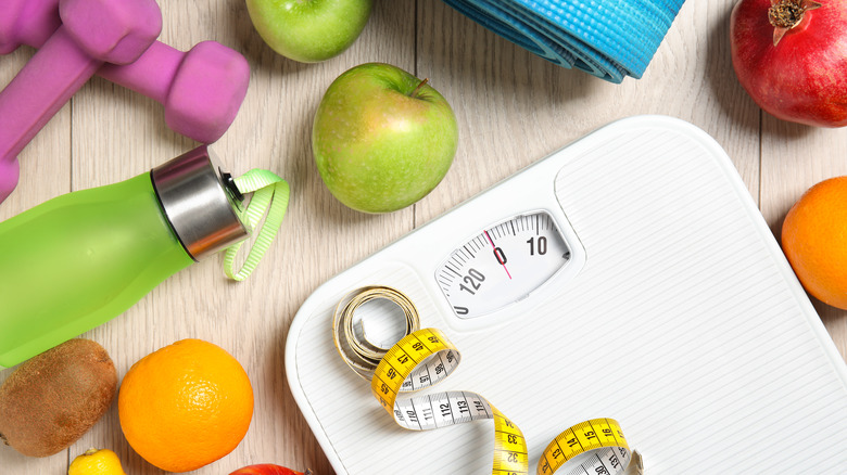 scale with food and fitness equipment