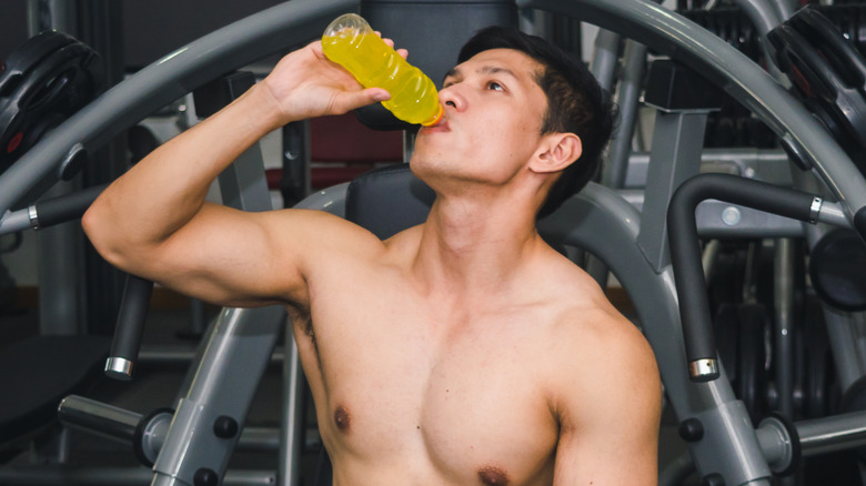 young man drinking sports drink