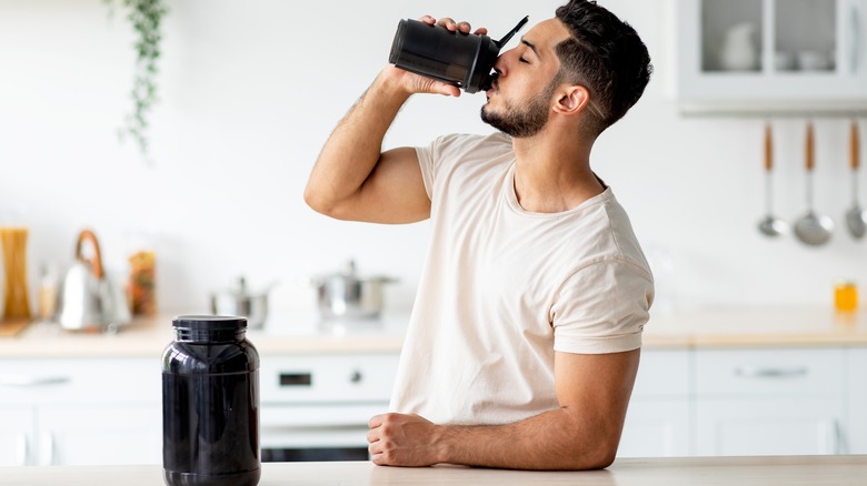young man drinking a protein shake