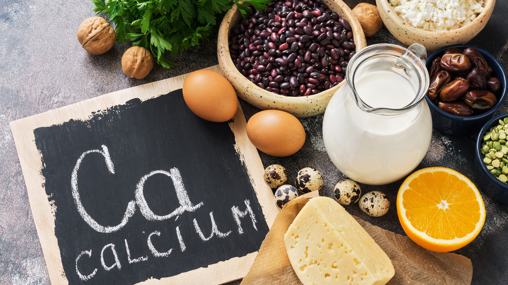 Calcium written on chalkboard surrounded by healthy food