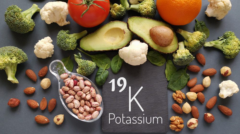 Potassium written on board surrounded by veggies and nuts