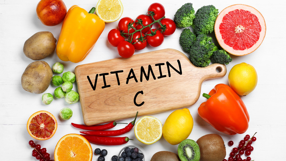 vitamin c on a board surrounded by veggies and fruits