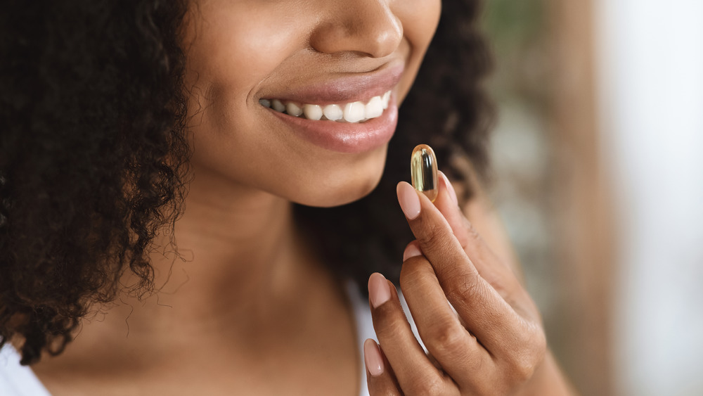 Woman taking vitamins