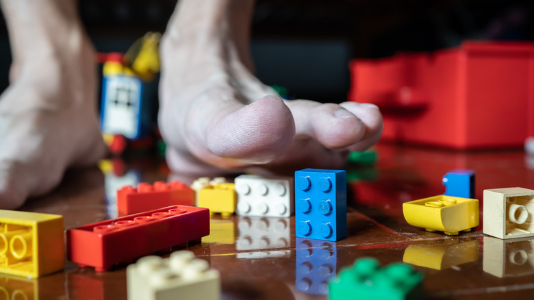 Person stepping on LEGOs