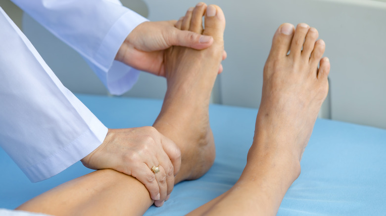 Doctor examines feet
