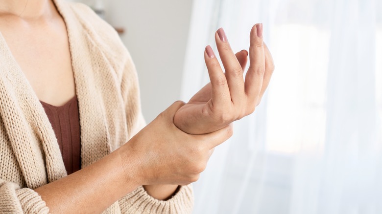 woman looking at her hand