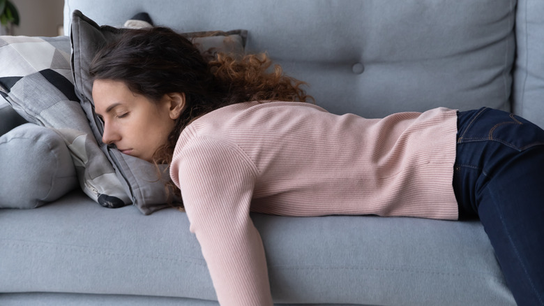 woman exhausted on couch