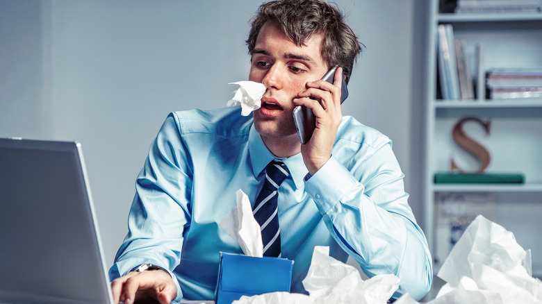 businessman on phone with tissues