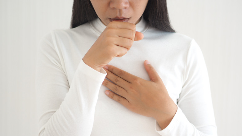 woman hand to mouth and chest