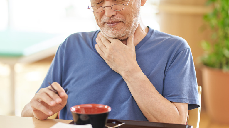 elderly man experiencing dysphagia