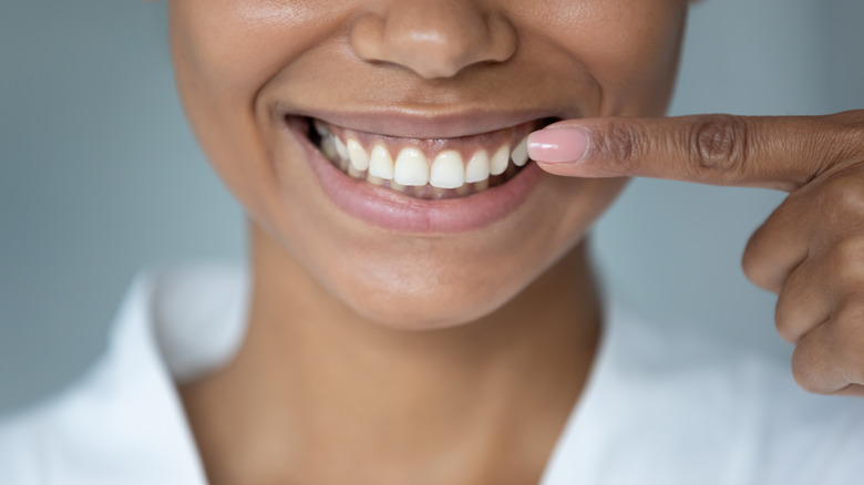 woman pointing at her mouth