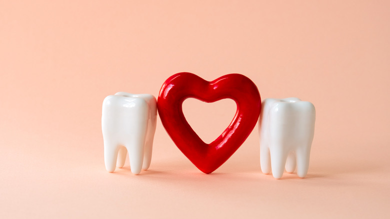 models of teeth and heart symbol