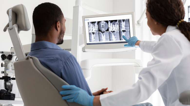 dentist showing x-rays to patient