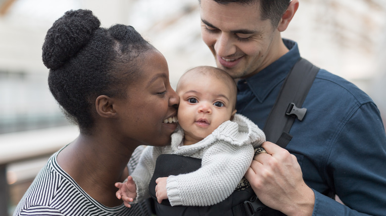 Happy parents traveling with newborn