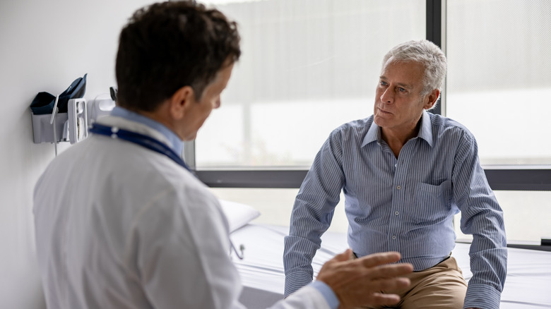 doctor talking to male patient