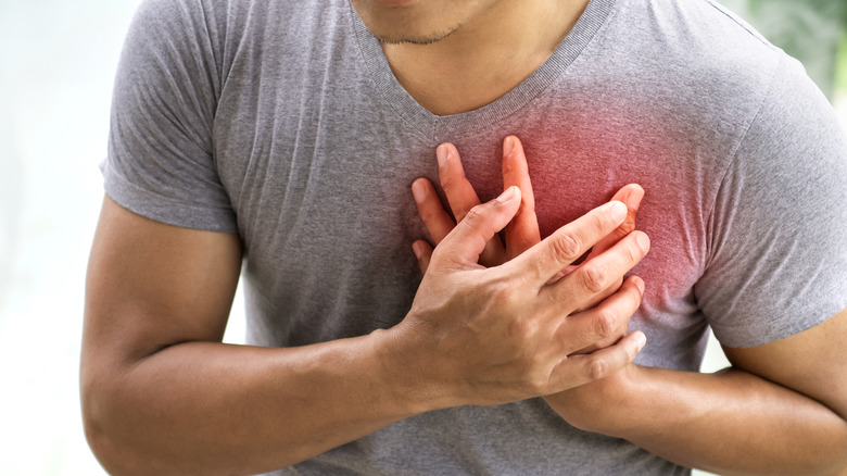 Man grabbing chest in pain