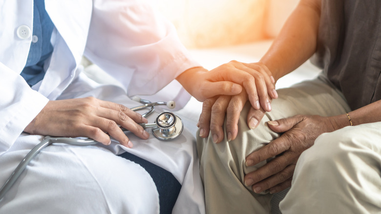 doctor holding Alzheimer's patient's hand