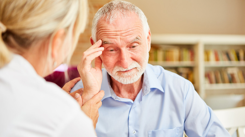 Alzheimer's elderly patient talking to doctor