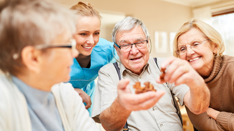 elderly people with nurse socializing