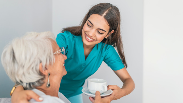 nurse attending to elderly patient