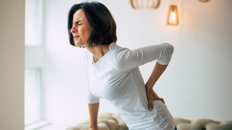 Woman holding back in pain