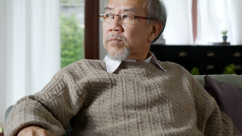 depressed man sitting on a sofa