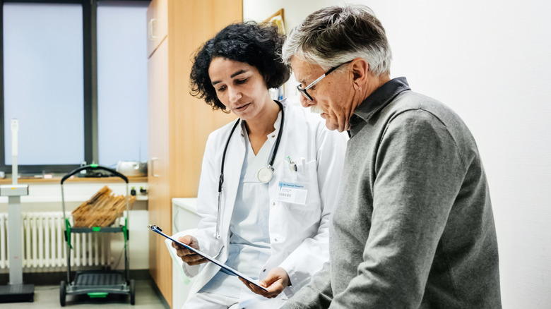 A man discussing test results with a doctor