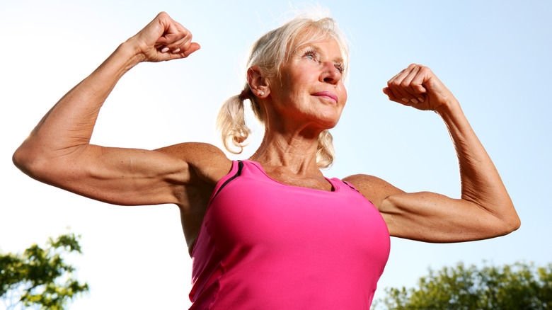 An older woman flexing her biceps