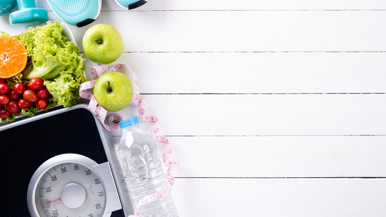 Scale with water, vegetables, fruit