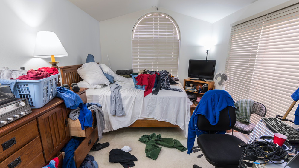 Lots of clutter in a messy bedroom