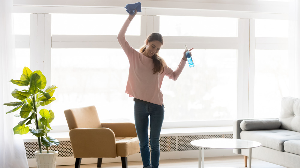 Woman cleaning and dancing