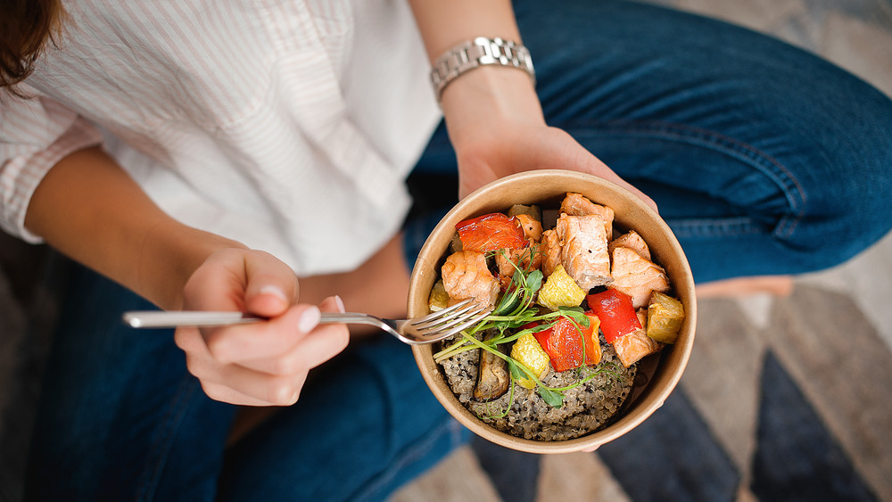 A woman eating a healthy bowl of food