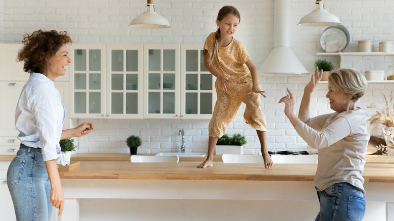 Family dancing in kitchen