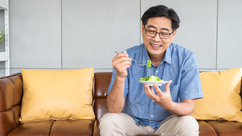 Elderly man eating