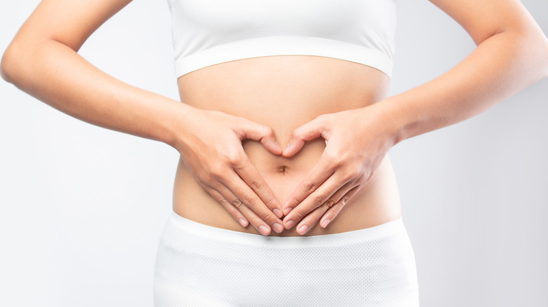 Woman holding stomach