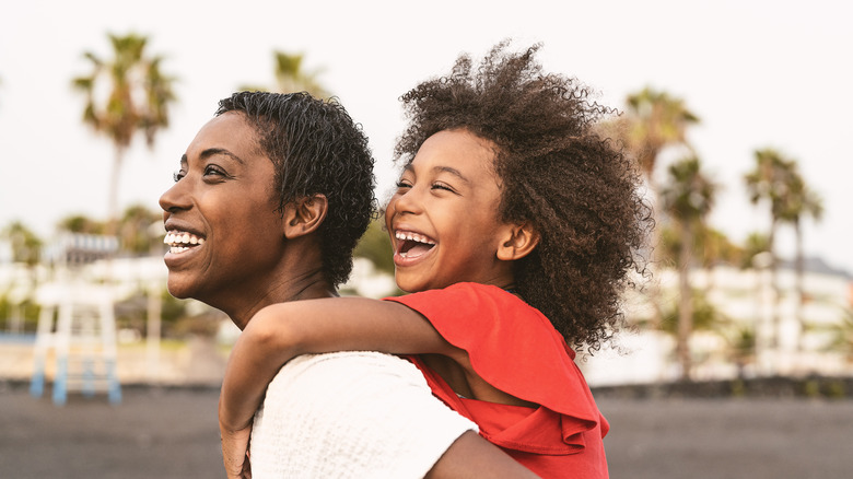 happy mother and daughter at beach