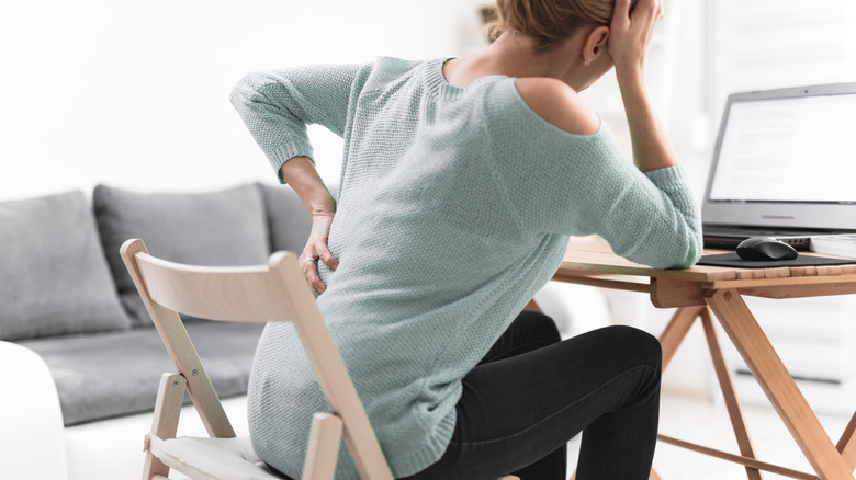a woman sitting down experiences hip pain
