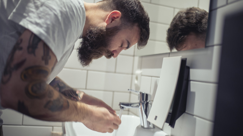 Man washing beard