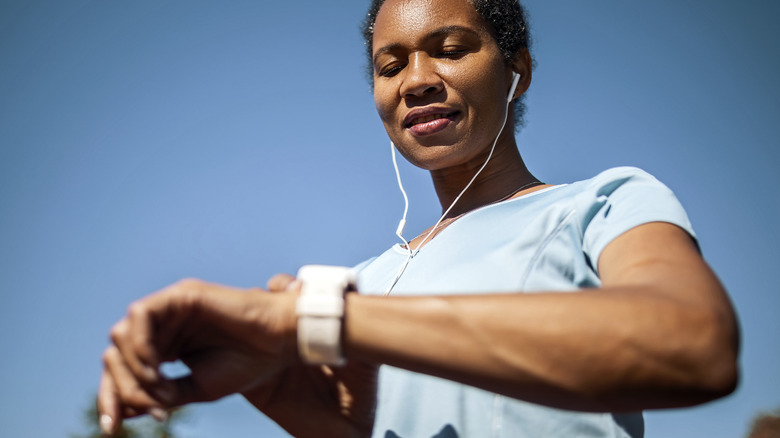 woman looking at her heart rate on her watch