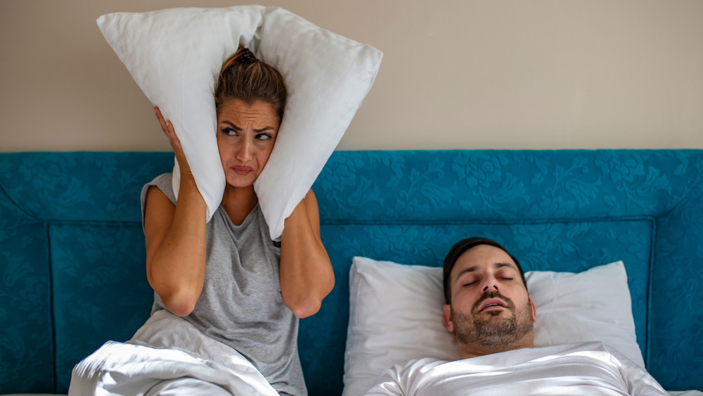 woman irritated man snoring