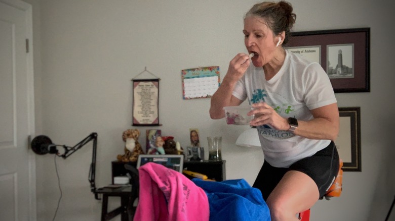 eating dragon fruit while on a stationary bike