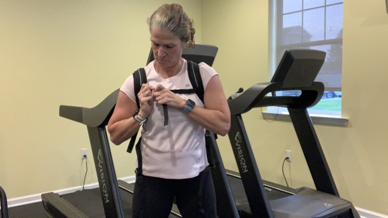 Woman taking off backpack at gym