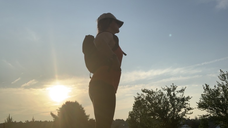 silhouette of woman with backpack