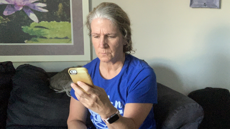 woman looking at her phone with curiosity