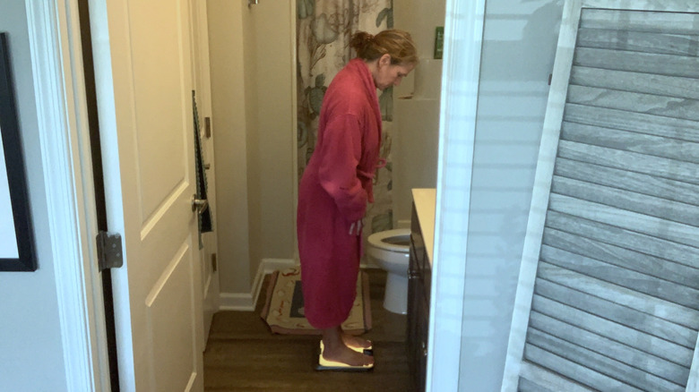 woman weighing herself in the bathroom